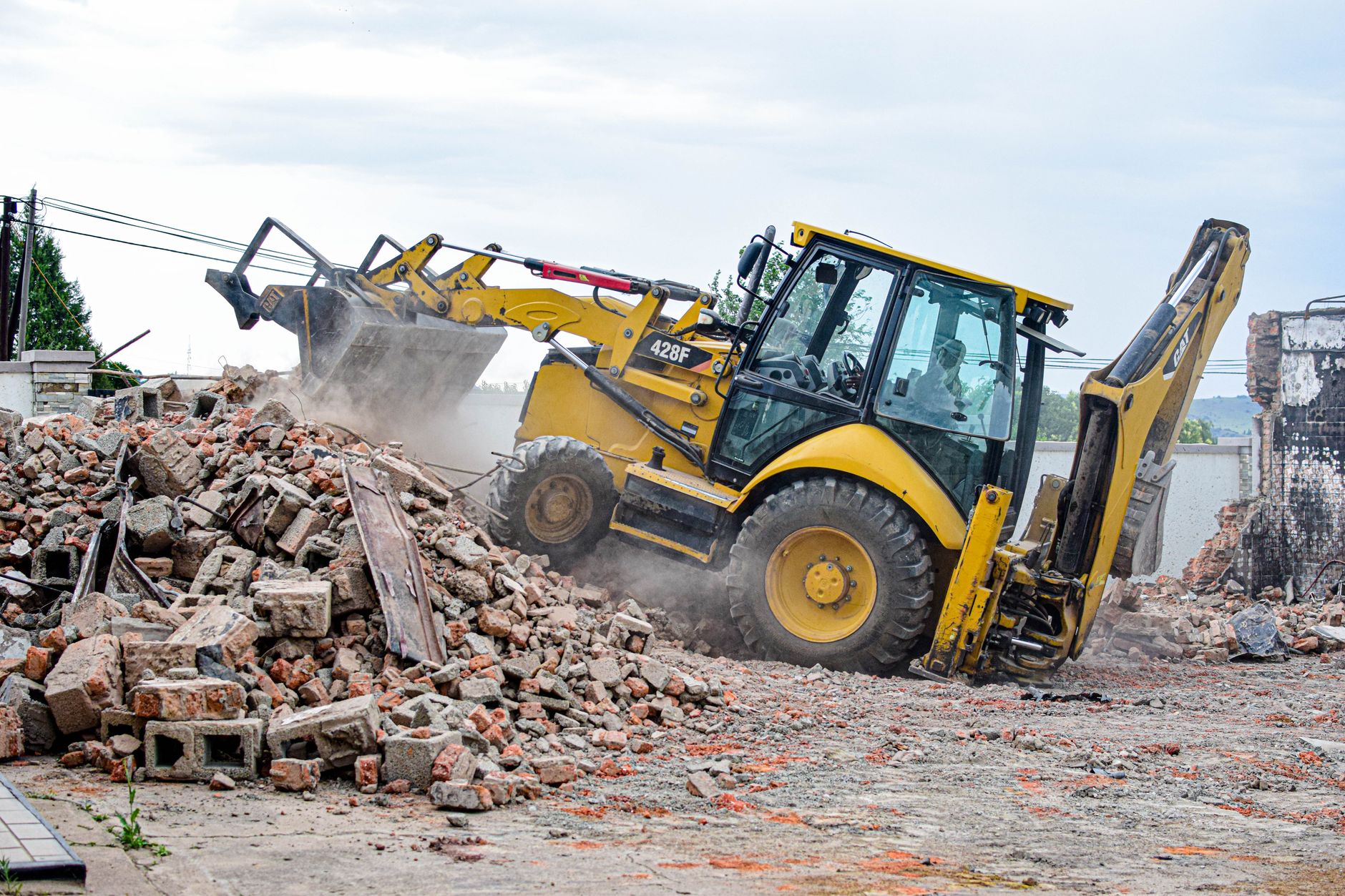 Excavator removing rubble at a demolition site