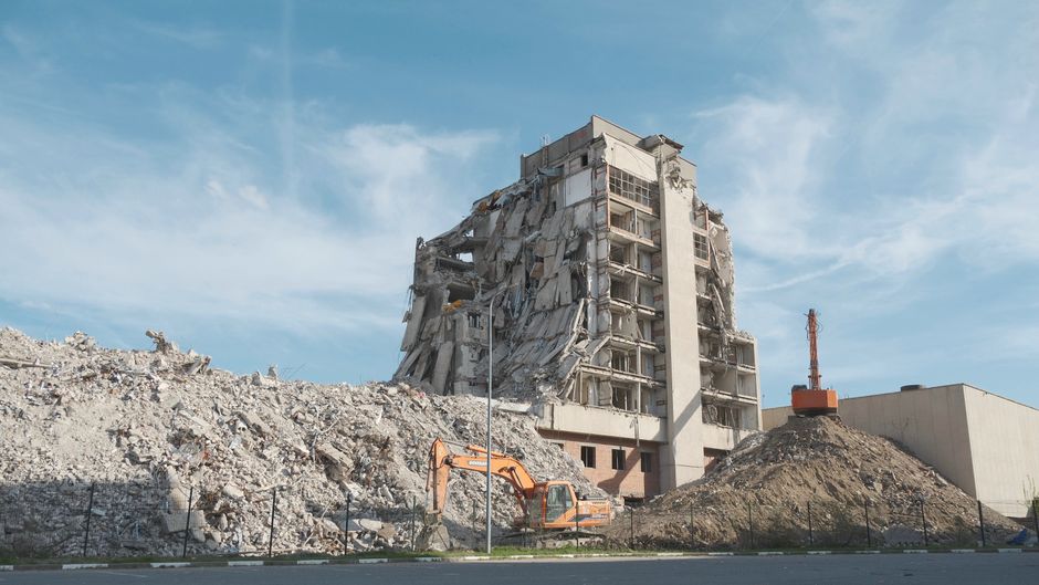 Excavator at work on a demolition site.
